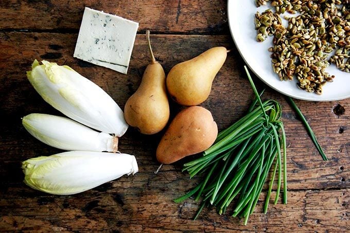 A board of endive, pear, blue cheese, chives and candied pepitas.