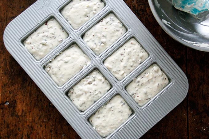 8-pan mini loaf pan filled with three seed cracker batter. 