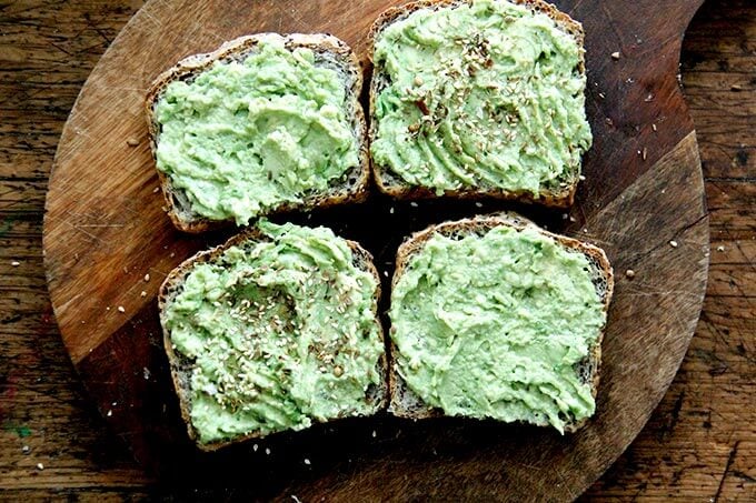 Toasted quinoa-flax bread, smeared with avocado, topped with dukkah.