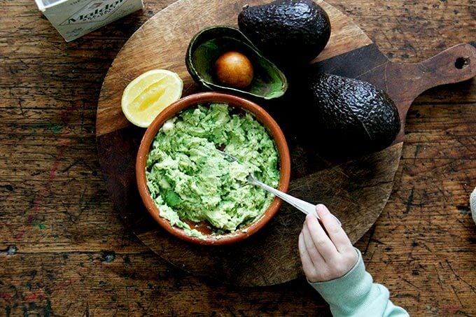 mashed avocado with lemon and salt in a bowl. 