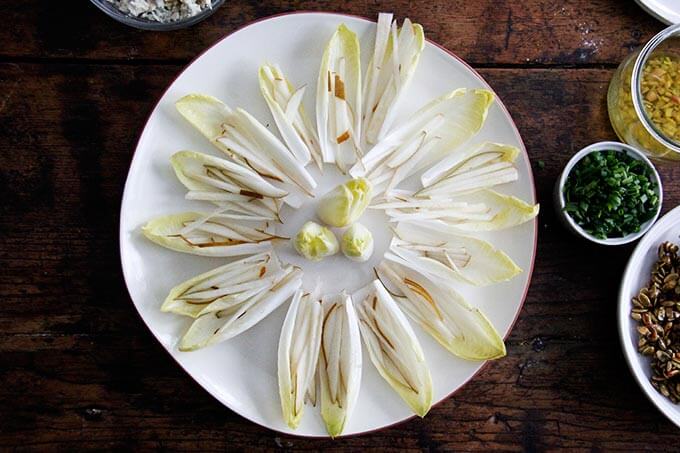 A platter of endive boats with slivered pears.