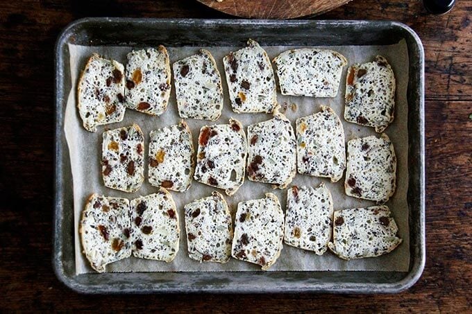 Sliced three seed crackers on a sheet pan. 