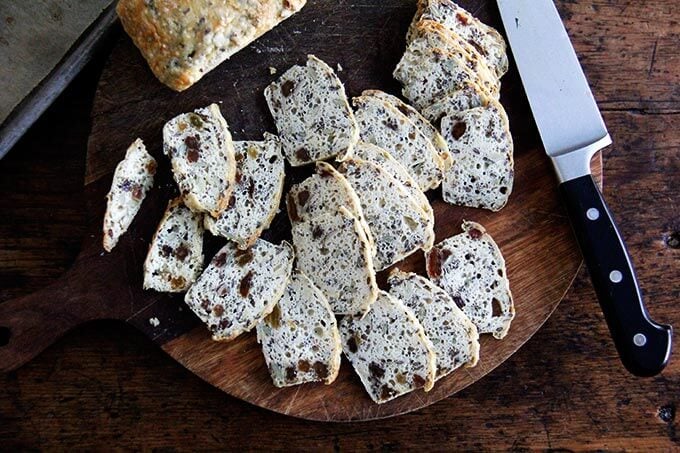 Sliced three seed crackers on a board.