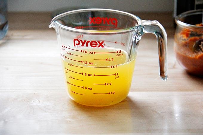 A liquid measure with fresh orange juice and water.