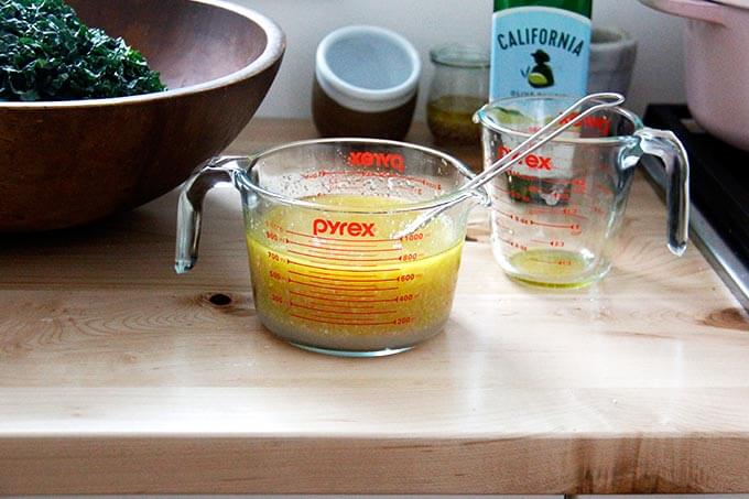 A quart measure holding the shallot vinaigrette.