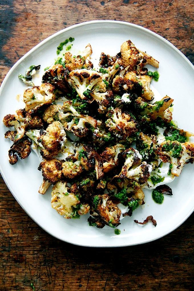A plate of roasted cauliflower with schug. 