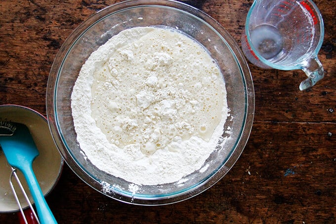 A bowl with wet ingredients added to dry ingredients. 