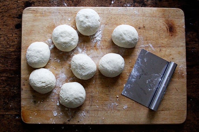 A board with portions of brioche dough shaped into balls. 