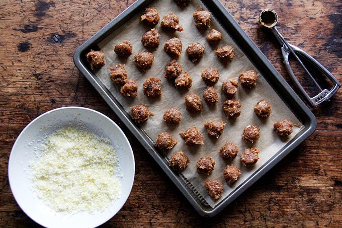 Lemon coconut date balls on a sheet pan. 