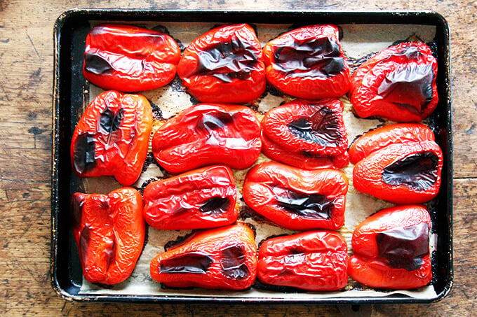 A sheet pan of roasted red peppers.