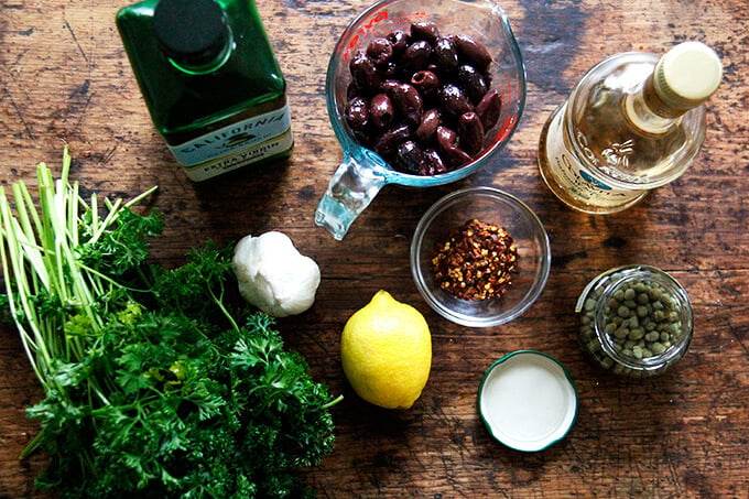 An overhead shot of the ingredients to make black olive tapenade.