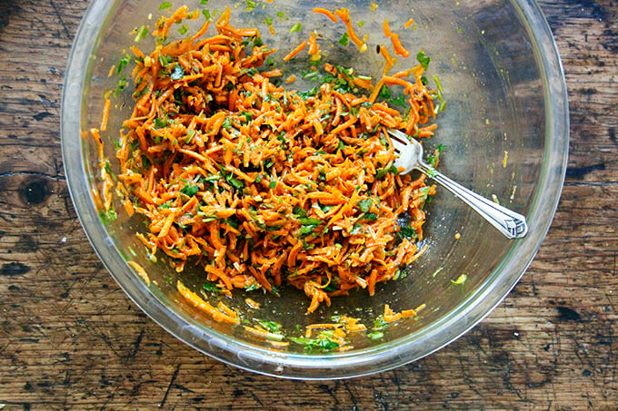 A bowl filled with Moroccan carrot salad all tossed together.