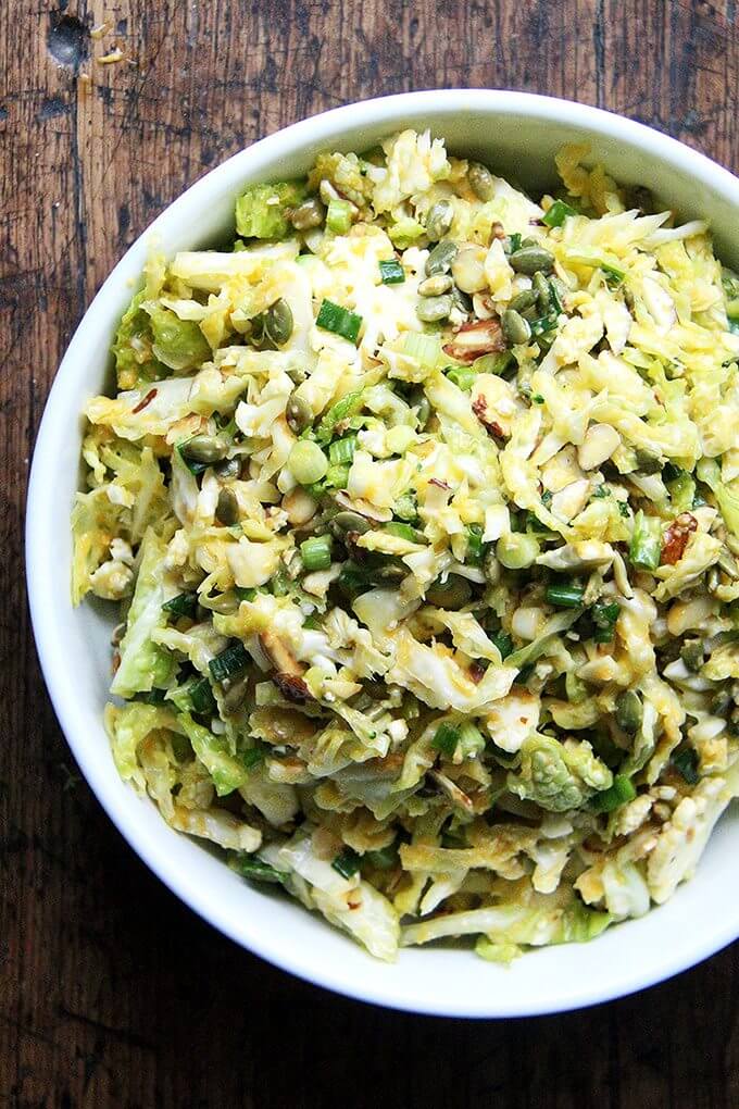 A bowl of cabbage salad with miso-carrot dressing.