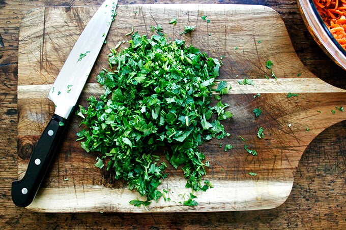 A board with minced cilantro on top.