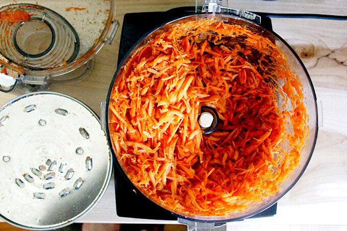 Grated carrots in a food processor.