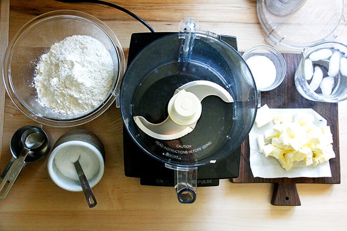 A counter with a food processor and the ingredients to make foolproof food processor pastry dough.