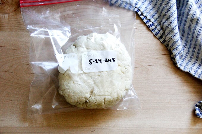 A round of food processor pastry dough in a ziplock bag with the date on it. 