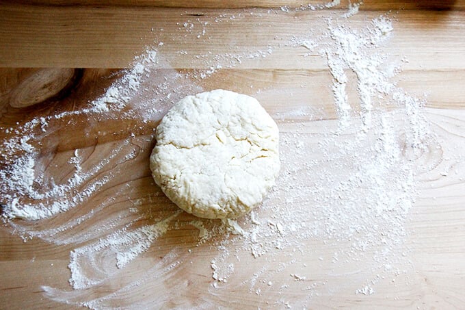 A floured board with a round of foolproof food processor pastry dough on it. 