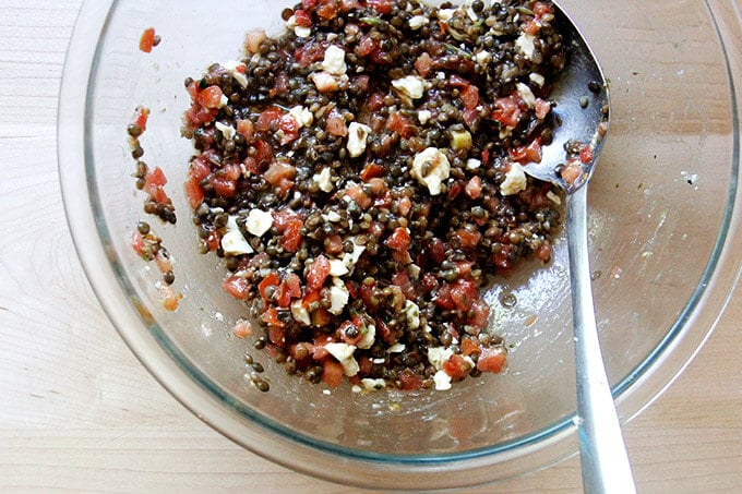 Bowl of lentils, bruschetta sauce and feta cheese all together.