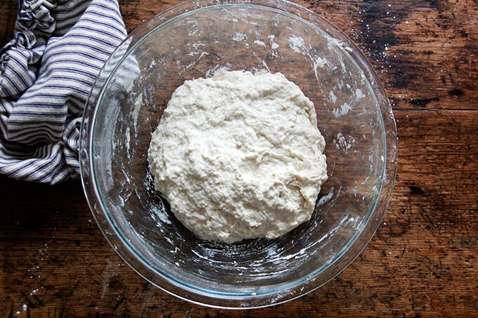 a bowl with mixed bread dough in it 