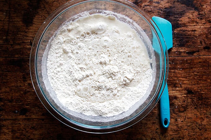 A bowl with bread dough about to be mixed. 