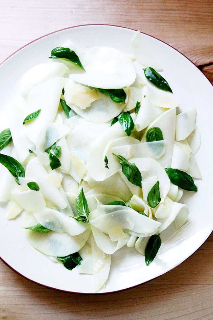 A platter of shaved Kohlrabi Salad with basil and parmesan. 