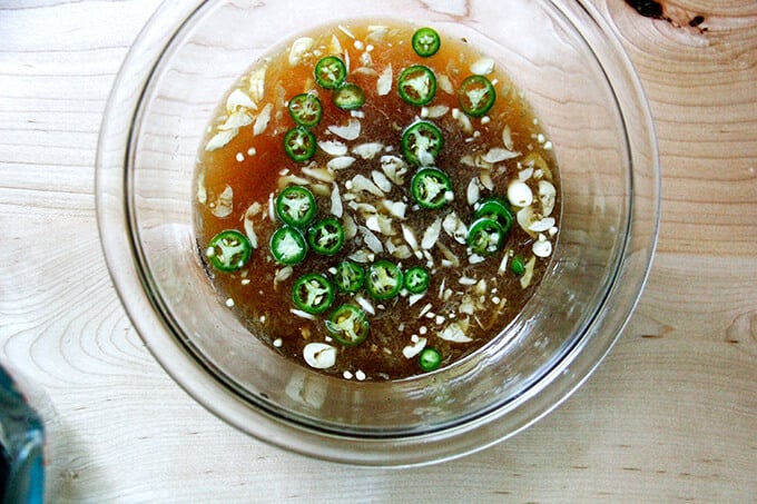 A bowl filled with homemade nuoc cham. 