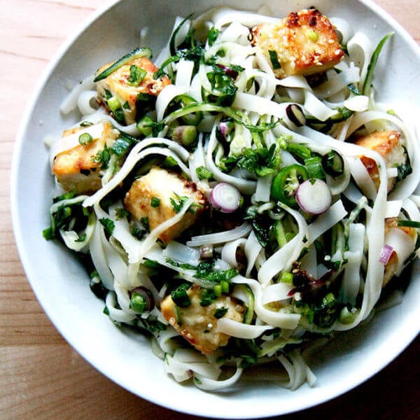 A bowl of rice noodles with herbs and nuoc cham.