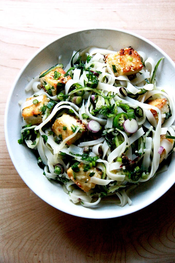 A bowl of rice noodles with herbs and nuoc cham.