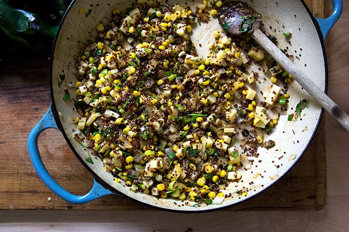 Sautéed vegetables plus quinoa and spices in a skillet. 