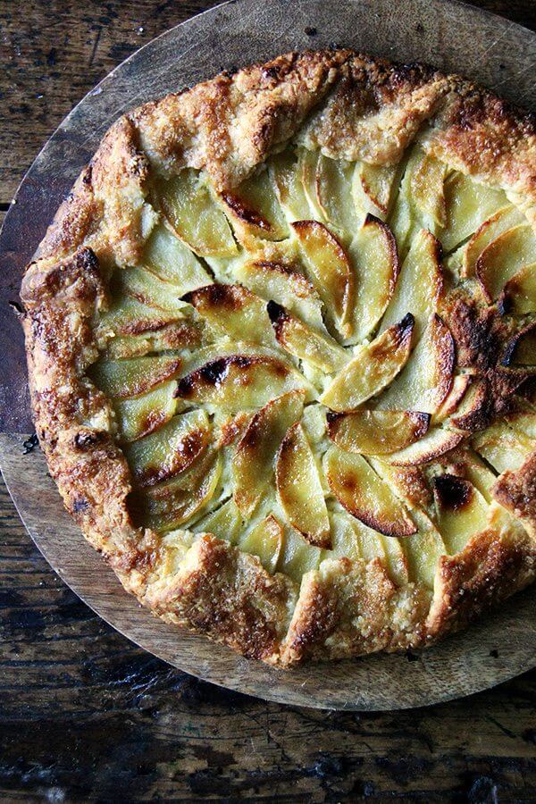 An apple-frangipane galette on a board.