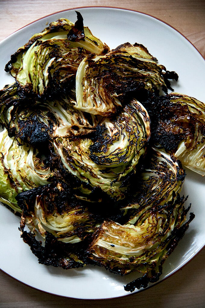 A platter with roasted cabbage wedges on top. 
