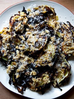 a plate of roasted cabbage wedges with walnuts, parmesan, bread crumbs and balsamic.