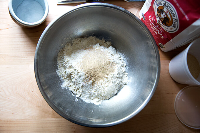 A bowl with flour, salt, and yeast. 