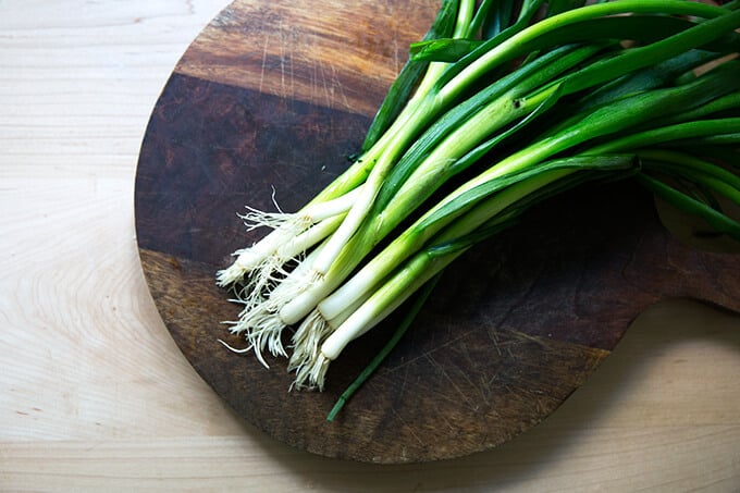 A board with scallions on top. 