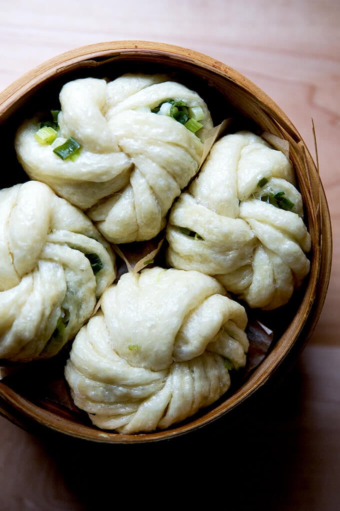 A steamer filled with Chinese steamed scallion buns.