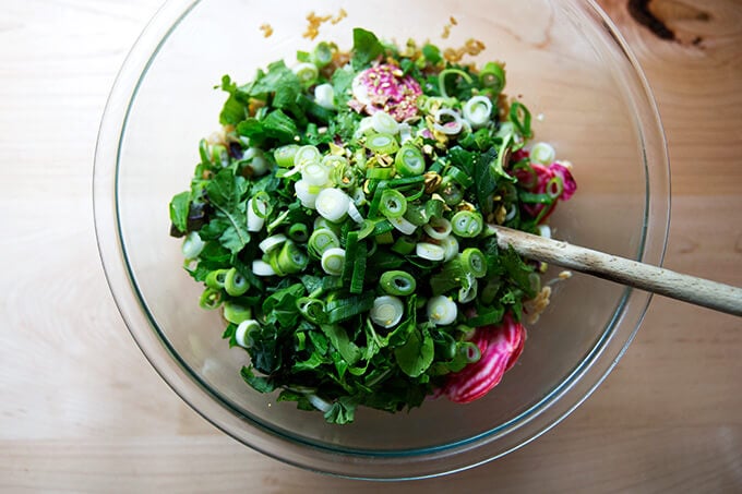 A bowl filled with a tossed farro salad.