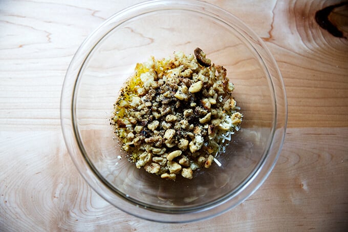 A bowl filled with ingredients for walnut salsa.