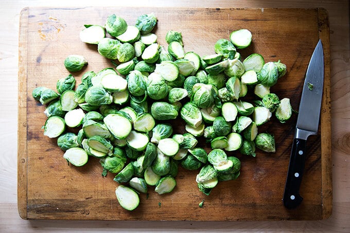 A board with halved Brussels sprouts.