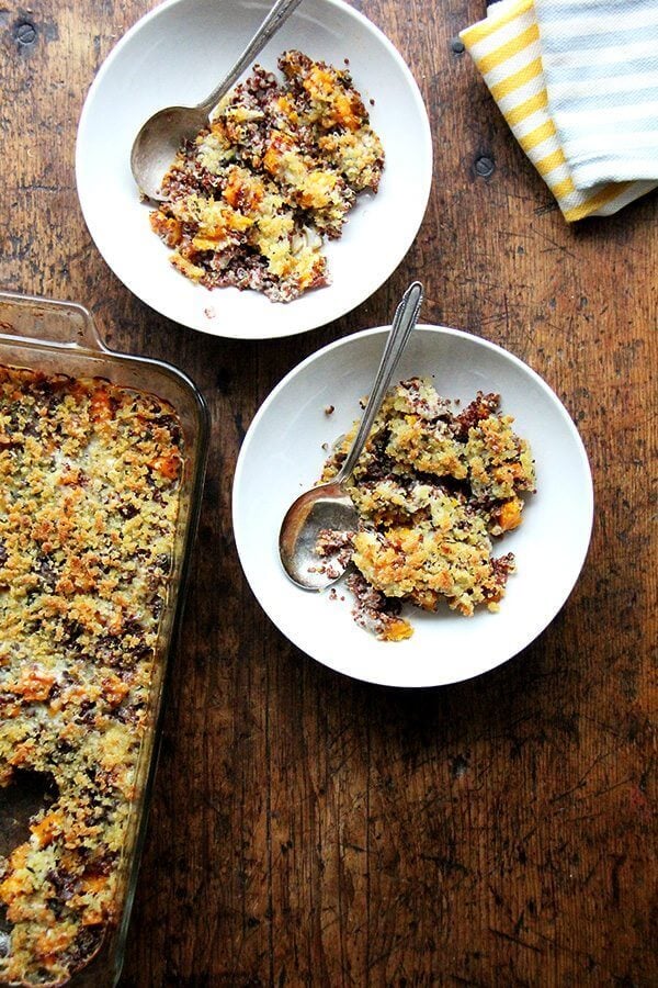 Bowls filled with quinoa bake with roasted butternut squash and onions.