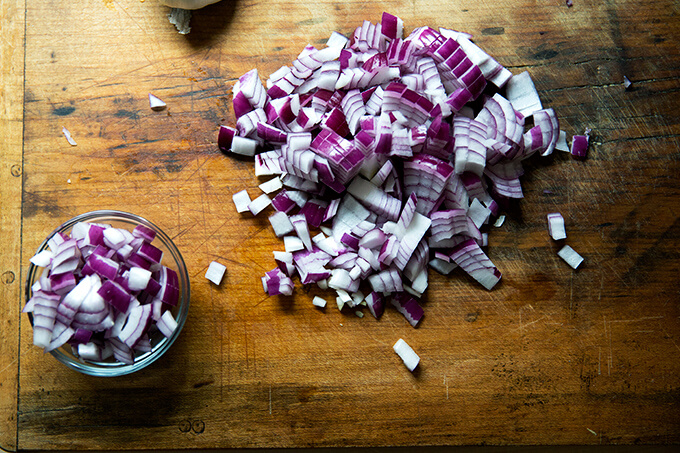 A board with diced red onion. 