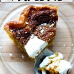 A slice of salted maple pie on a plate with whipped cream.