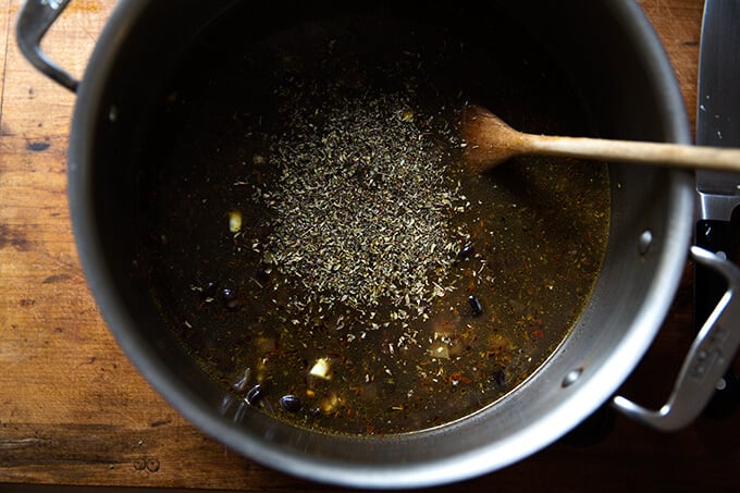 A pot with all of the ingredients for black bean soup. 