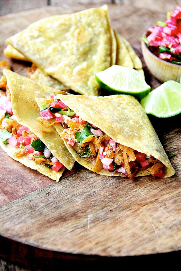 A board topped with sweet potato quesadillas. 