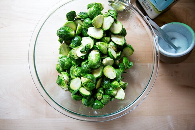 A bowl of Brussels sprouts tossed with olive oil and salt. 