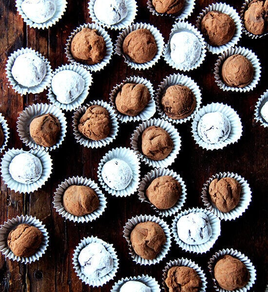 An overhead shot of a table lined with boozy chocolate truffles.