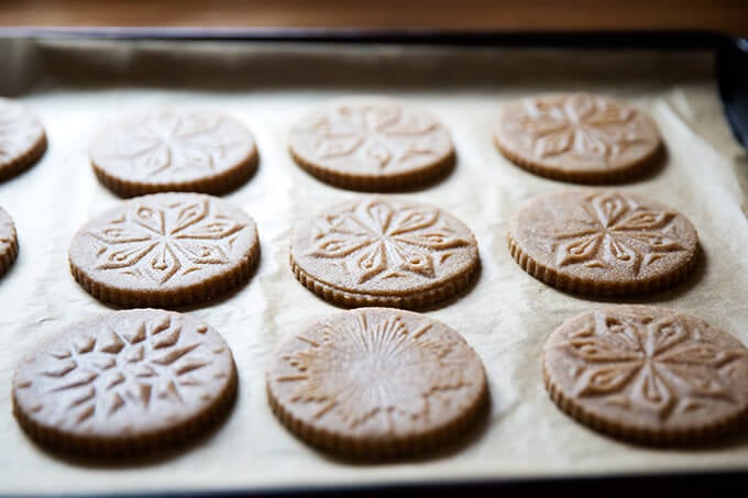 Stamped spiced brown butter muscovado cookies unbaked on cookie sheet. 