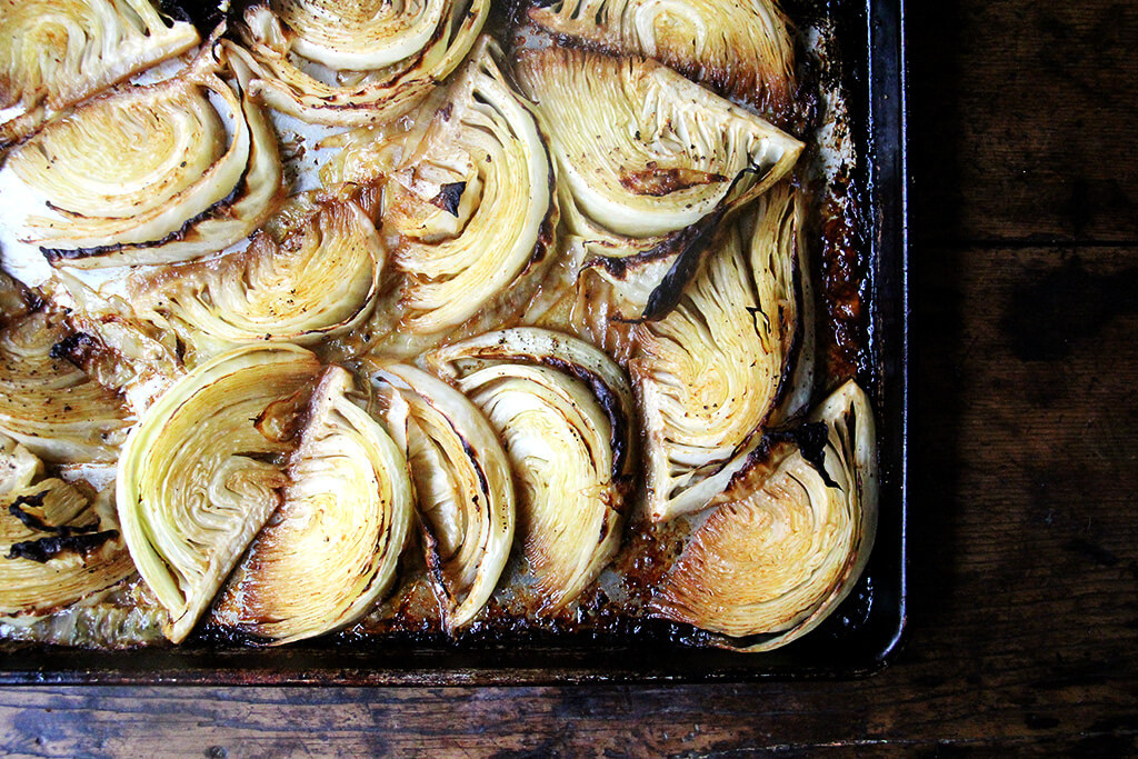 A sheet pan of roasted cabbage wedges.