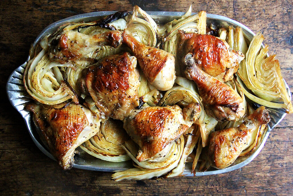A platter of sheet pan roast chicken and cabbage.