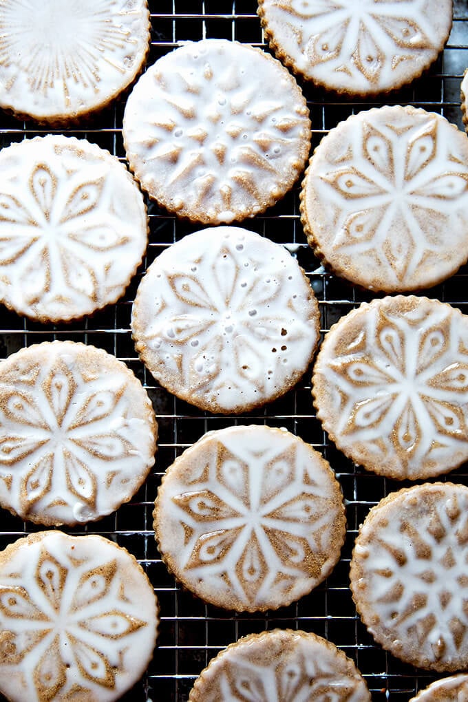 Stamped spiced brown butter muscovado cookies with maple glaze on a cooling rack.